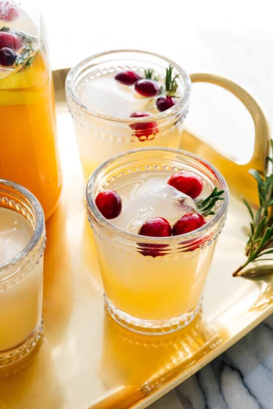 A pitcher and two glasses of Vanilla-Pear Holiday Punch, the perfect Christmas cocktail.