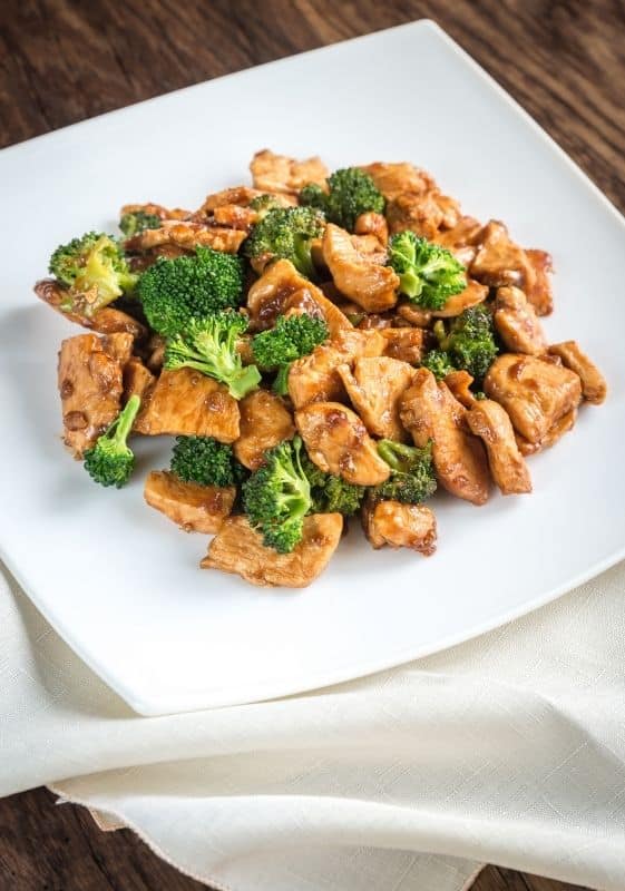 Chicken broccoli on a white plate.