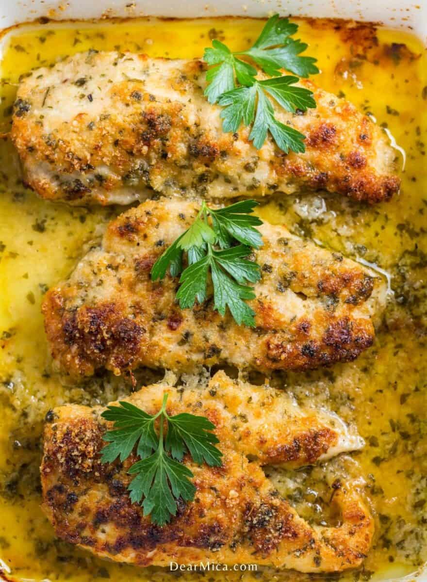 closeup view of Baked Chicken Breast with Garlic Butter Sauce garnished with parsley