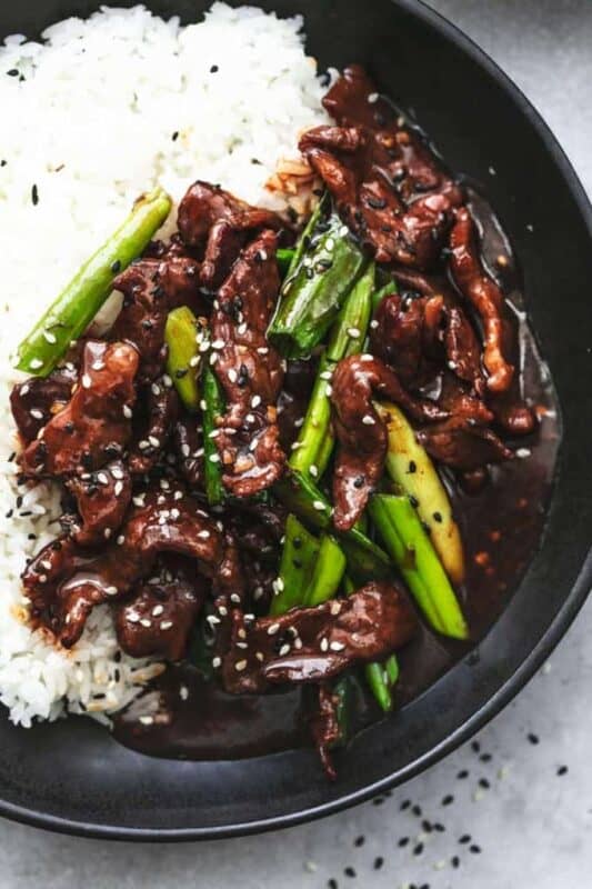P.F. Chang’s Mongolian Beef (Copycat) served on a black plate over white rice.