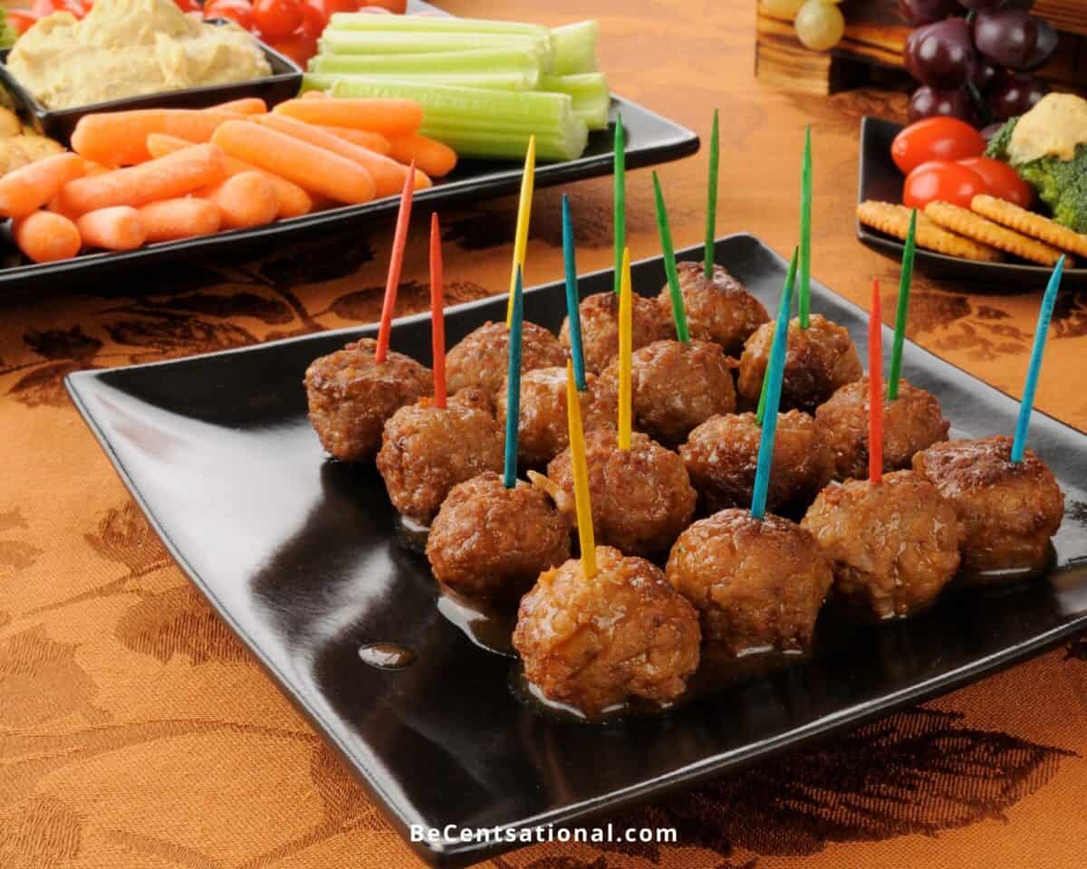 Best Super Bowl Snacks on table setting with meatballs and vegetable platter with dip.