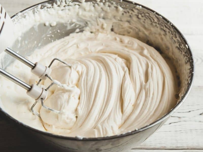 Cheesecake batter in a metal bowl with mixer whisk. Can You Freeze Cheesecake Batter?