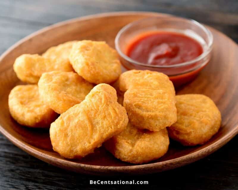 Side view of chicken nuggets served with ketchup on the side. Can You Reheat McDonald’s Chicken Nuggets.