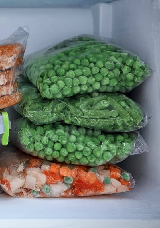 Bags of frozen peas in the freezer. Does Frozen Peas Go Bad.