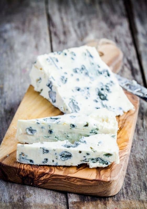 Blue cheese in a wood board. Foods with blue.