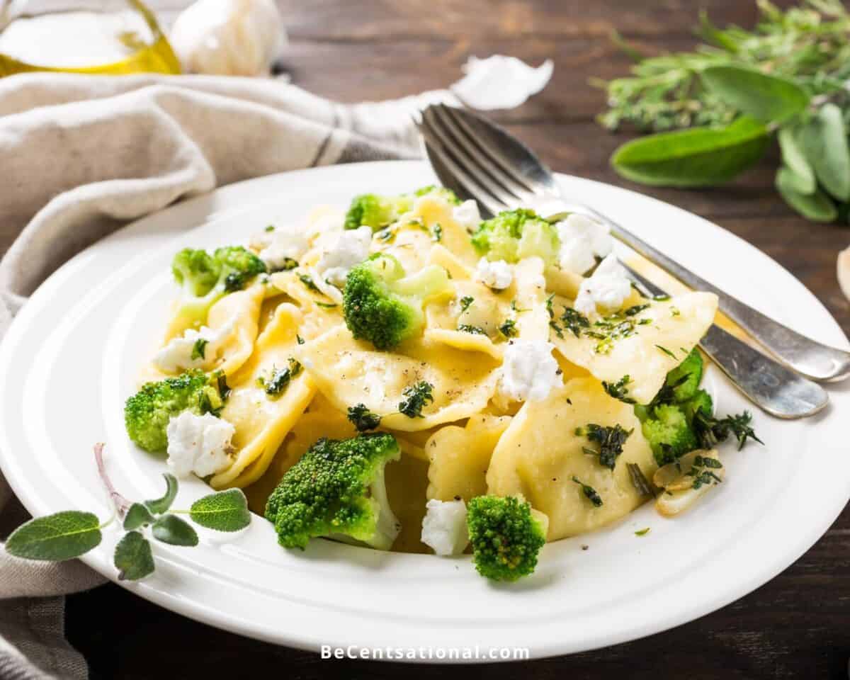 Ravioli with broccoli on a white plate set on a wooden table for a cheap Aldi Meal Plan.