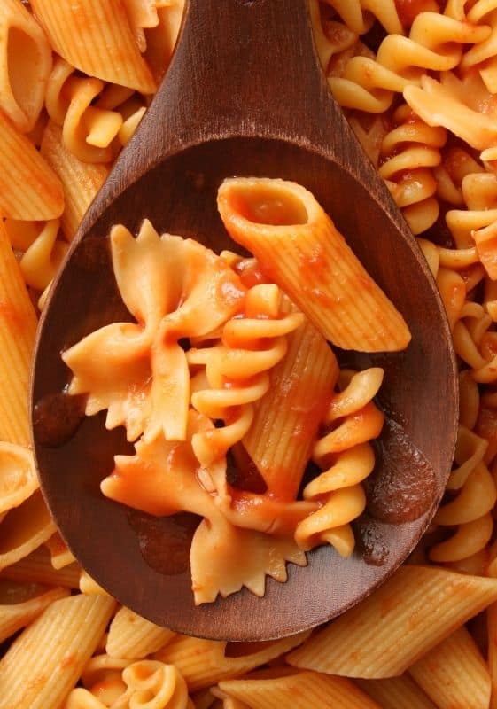 Different types of pasta cooked together in the sauce.