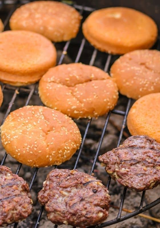 Beef burger patties and burger buns on the grill.