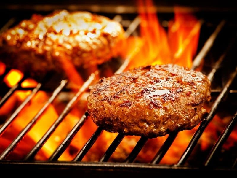 View of two burgers in the grill. Can You Grill Frozen Burgers on Gas Grill