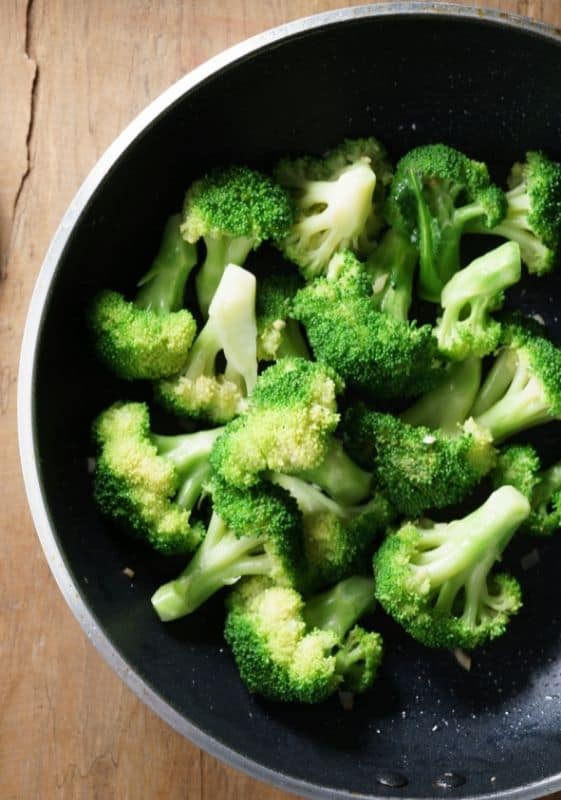 Steamed broccoli on stovetop.