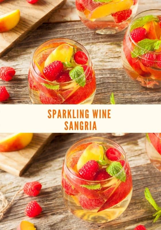 Top view of three glasses of Sparkling Wine Sangria with peaches and raspberries with a cutting board on the background with fruits on it.