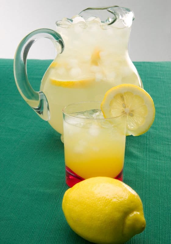 Pitcher of lemonade on a green mantel.