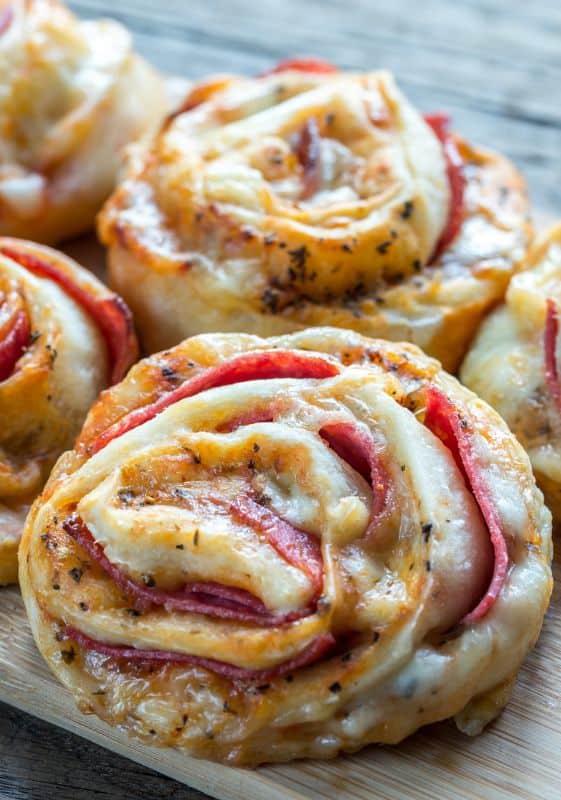 Closeup view of Pepperoni Pizza Crescent Rolls on a wooden board.