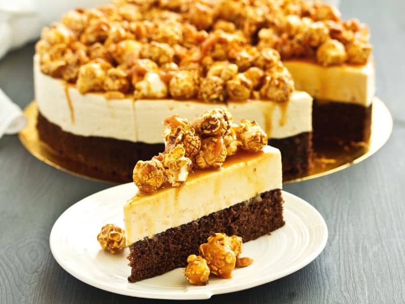 A chocolate caramel cheesecake with caramel popcorn part of these Thanksgiving cheesecake recipes.