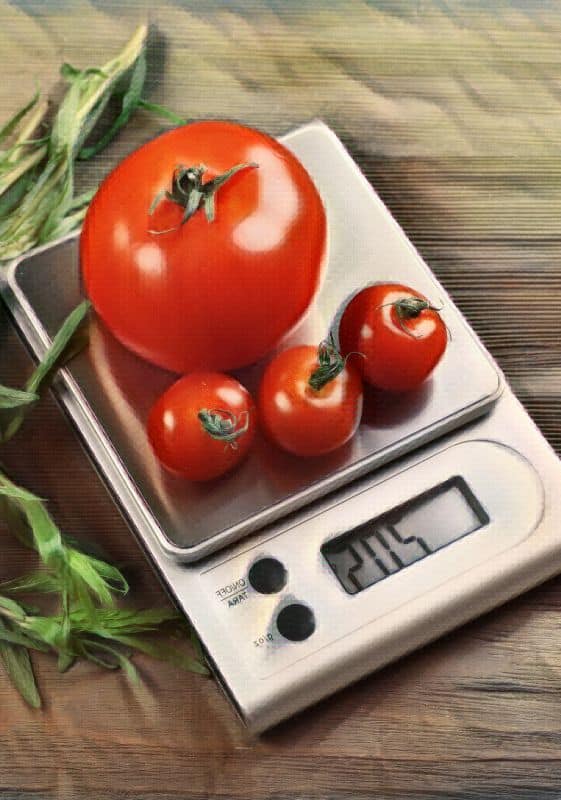 A digital food scale with tomatoes on it.