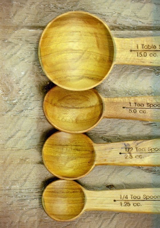 Four wooden measuring teaspoons.