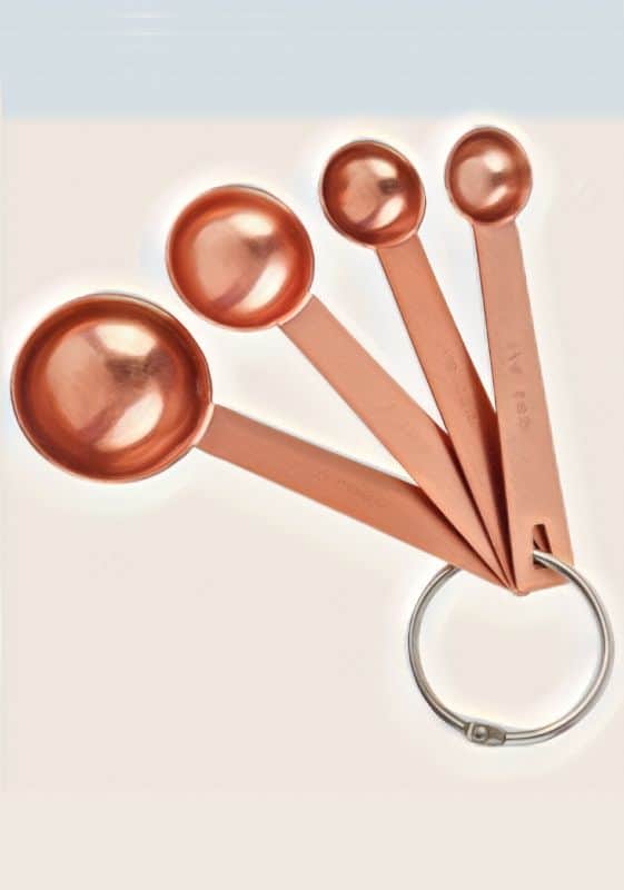 Copper measuring teaspoons in different sizes.