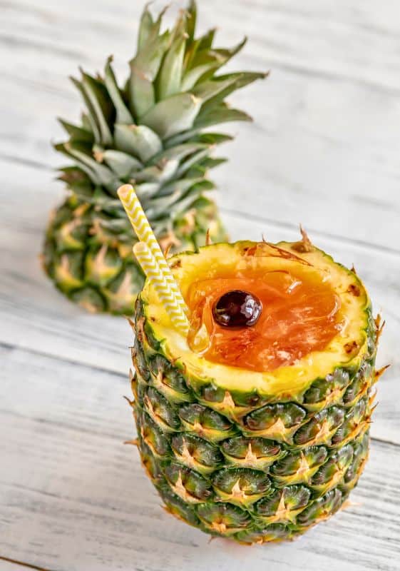 Best Captain Morgan drinks. A Bahama mama cocktail served on a pineapple.