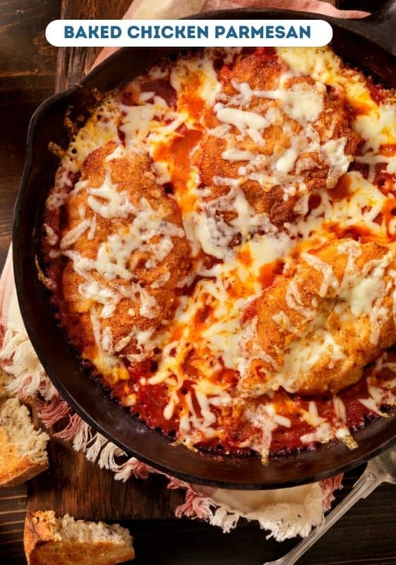 Baked chicken parmesan on a cast iron skillet.