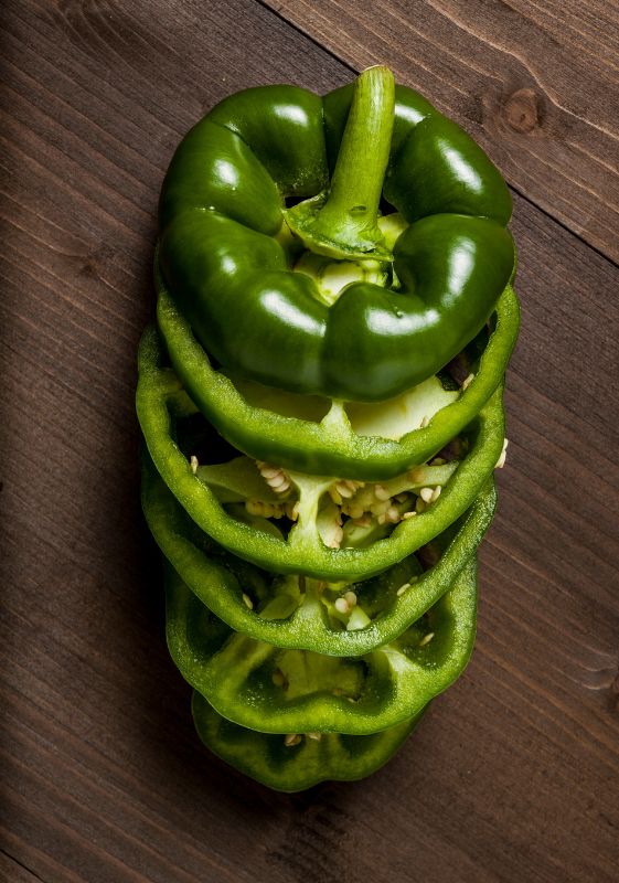 A green bell pepper sliced for a supreme pizza.