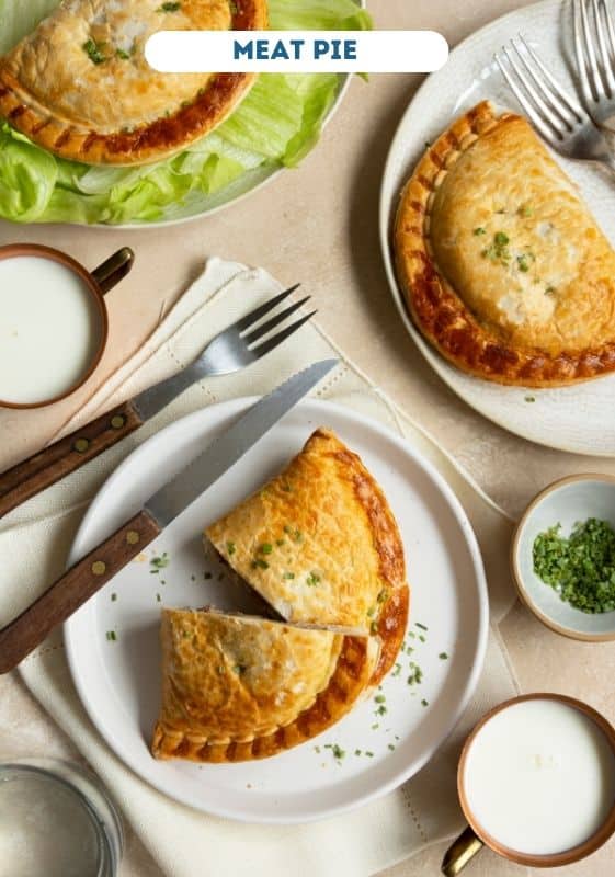 Meat pies on white plate.
