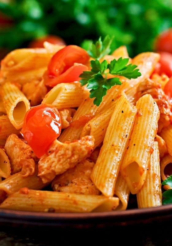 Closeup photo of tomato chicken pasta.