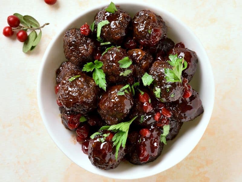 Image of cranberry BBQ crockpot meatballs: A close-up image of cranberry BBQ crockpot meatballs, showing the sweet and tangy sauce that they are coated in.