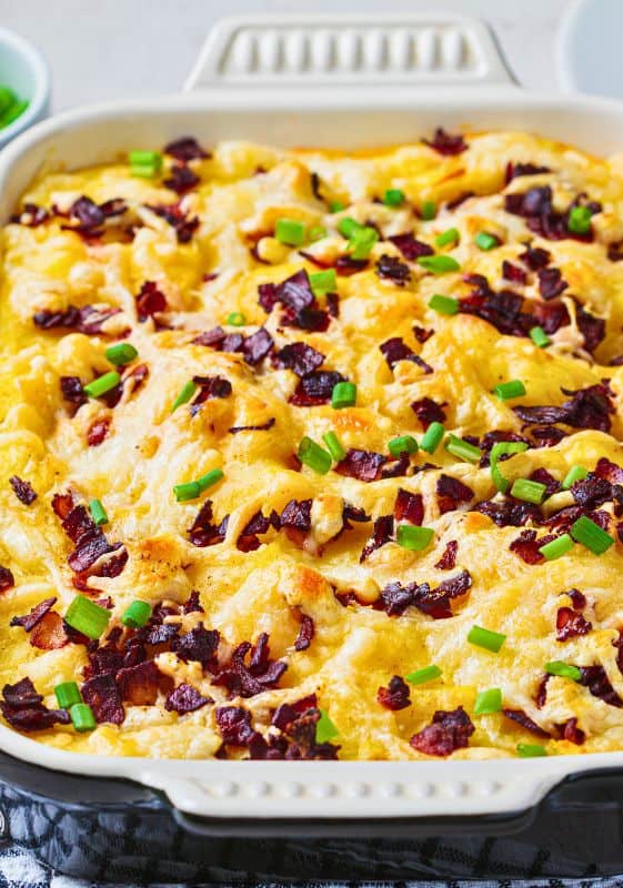 An image displaying the close-up view of Mashed Potato Casserole with crispy bacon on top.