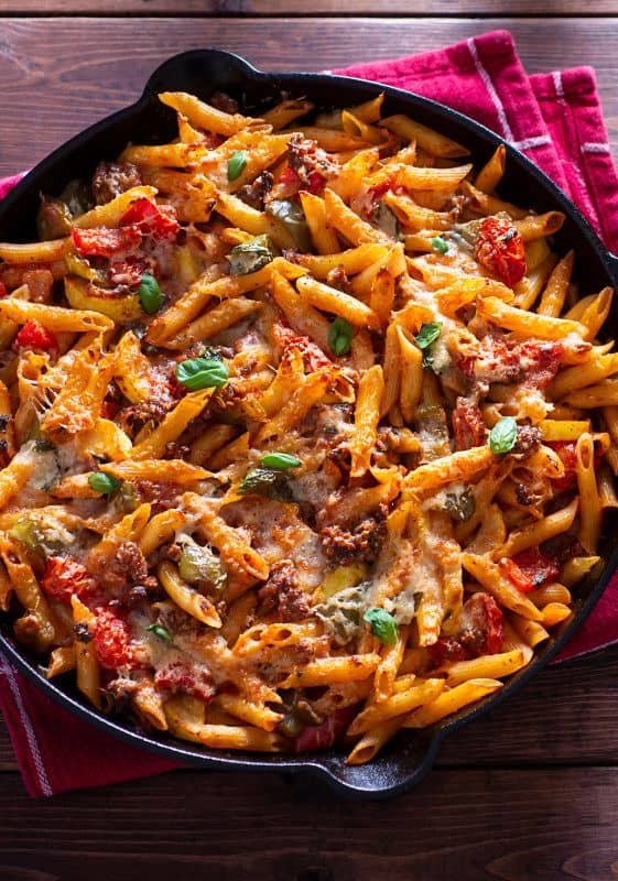A rustic Italian sausage pasta in a cast iron skillet.