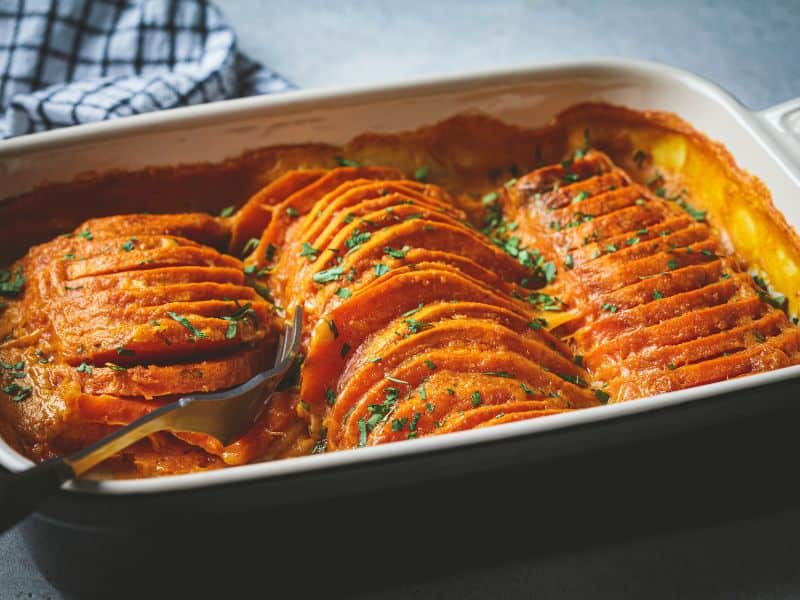 side view photo of sweet potato gratin in a baking dish. Sweet potato recipes.