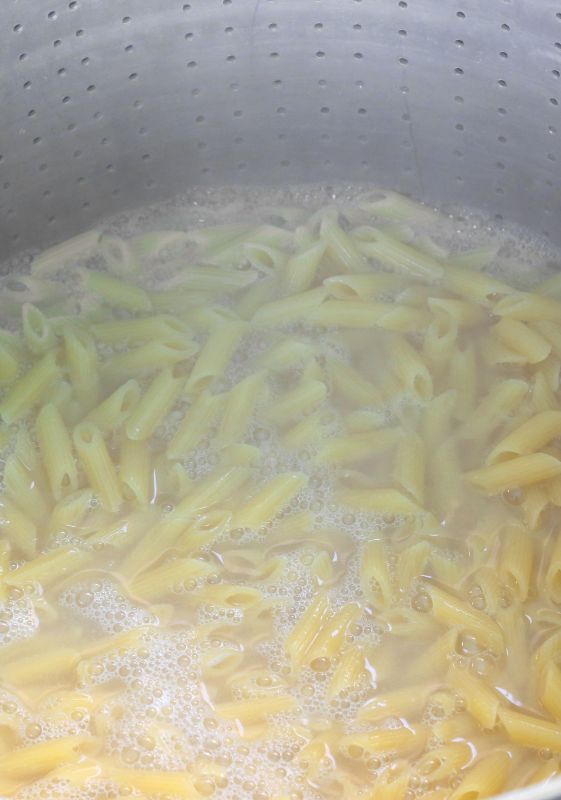 Penne pasta boiling in a pot.