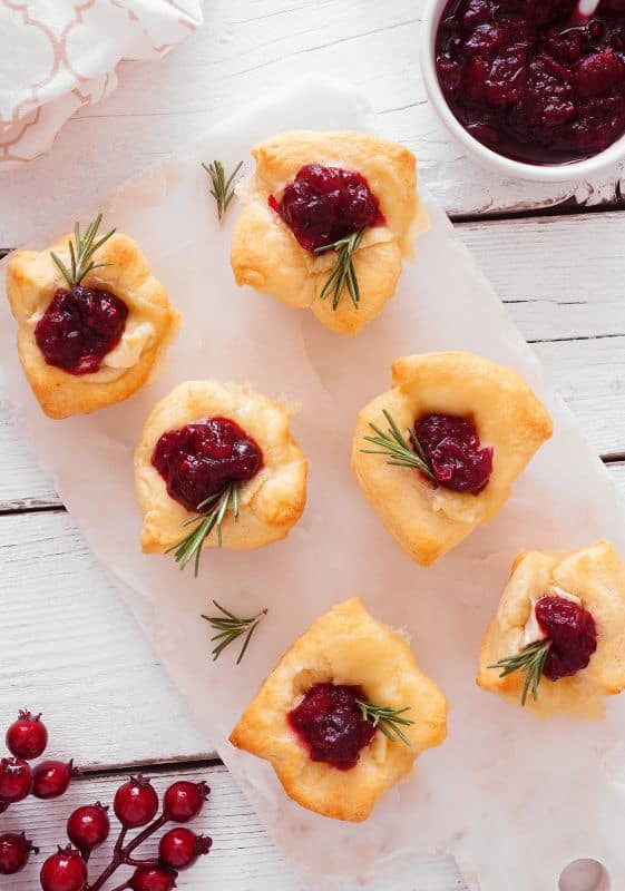 Image of Cranberry Brie Bites on a Serving Platter:Delicious Cranberry Brie Bites arranged on a festive serving platter, featuring flaky puff pastry, tangy cranberry sauce, and creamy brie cheese.