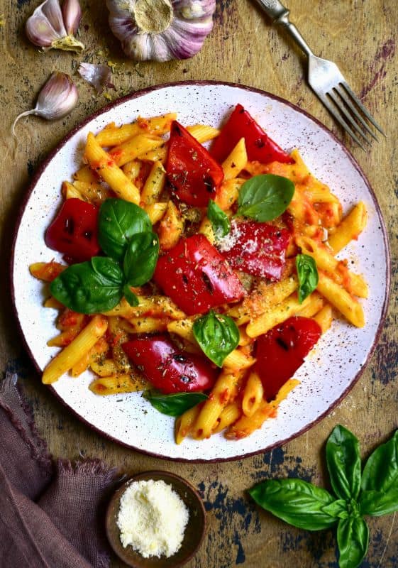 A delectable serving of Vegetarian Rasta Pasta highlighting the flavorful tomato sauce, colorful bell peppers, and a medley of spices, creating a delightful fusion of Italian and Caribbean cuisines.