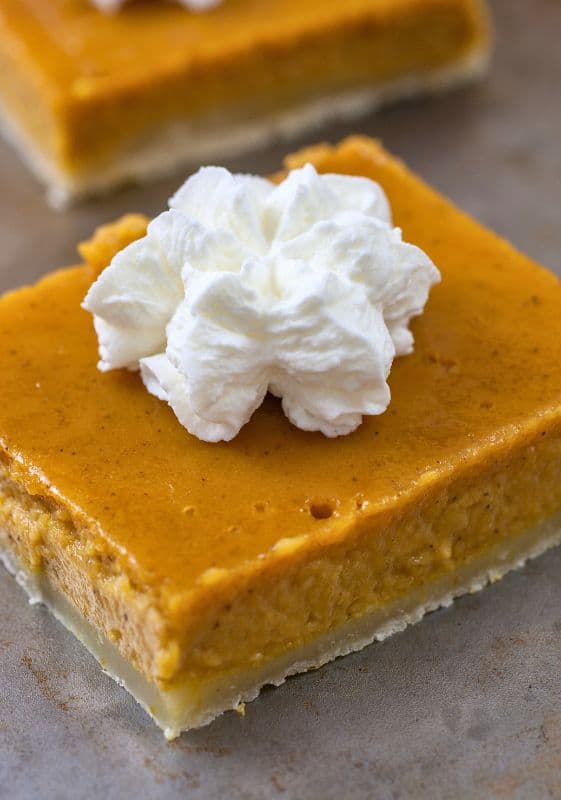 Healthy Pumpkin Pie Bars with whipped cream.