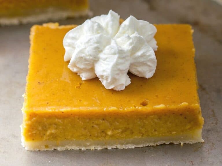 Top view of a Healthy Pumpkin Pie Bar with whipped cream.