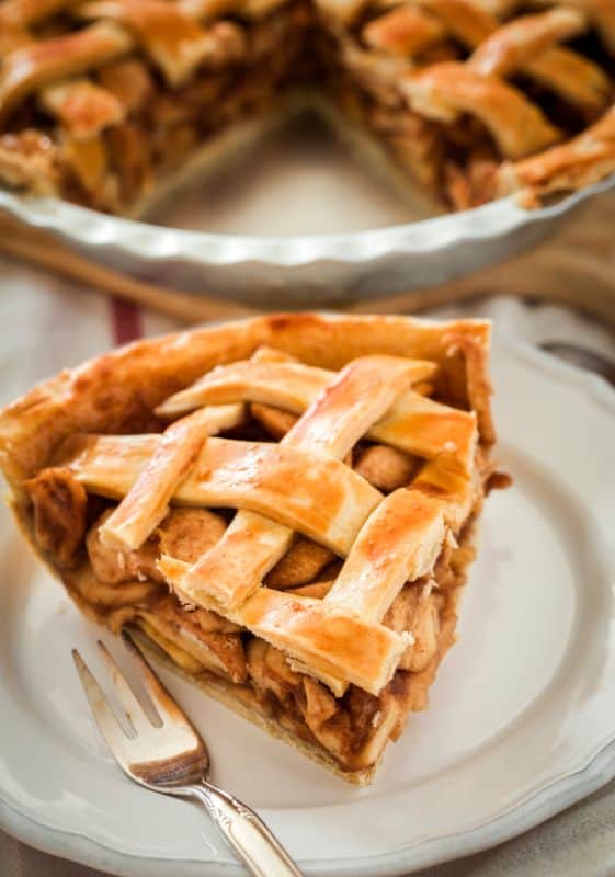 Slice of a healthy apple pie on a white plate.Healthy Thanksgiving desserts.
