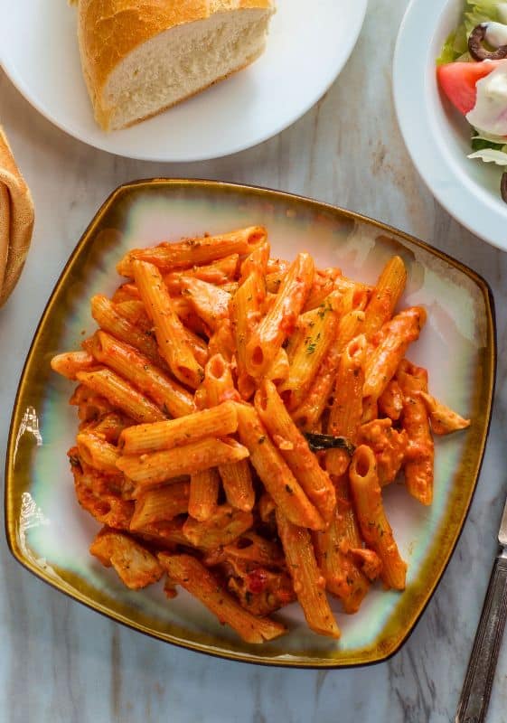 Penne alla Vodka with Chicken served on a dining table, ready for an elevated weeknight dinner or dinner party.
