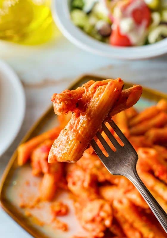 A close-up image of Penne alla Vodka with Chicken, highlighting the creamy tomato sauce and visible pieces of tender chicken.