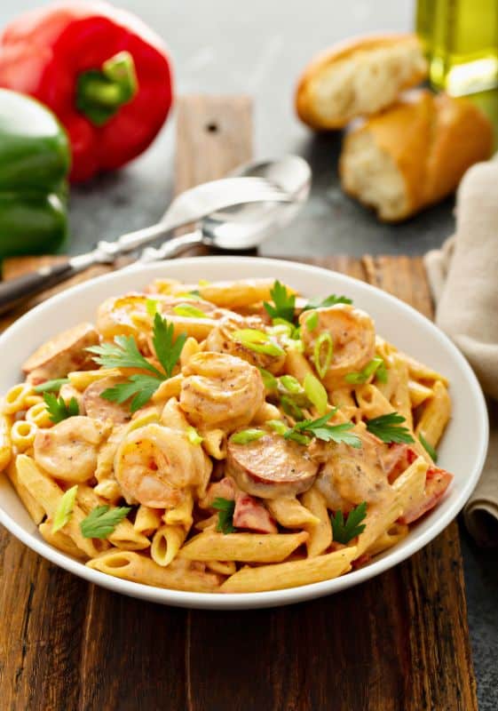 Cajun shrimp and sausage pasta, rich with Southern flavors and creamy sauce served on a white plate.