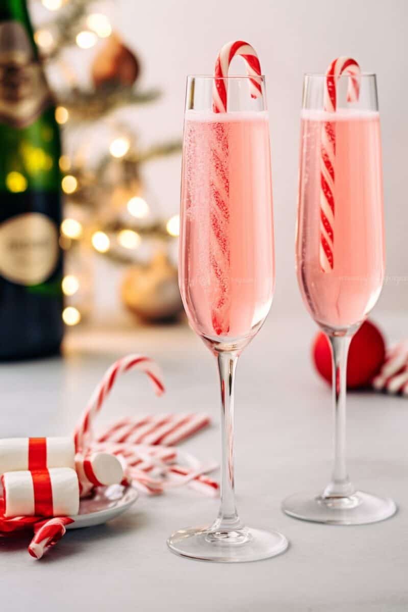 A pair of Peppermint Mimosas showcasing a harmonious blend of minty and sweet flavors, a festive recipe for holiday parties.