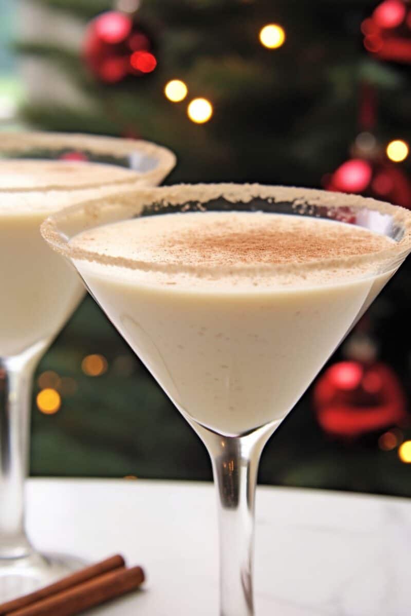 Two Creamy Eggnog Martini in a chilled glass, garnished with cinnamon and nutmeg, embodying the essence of holiday celebrations.