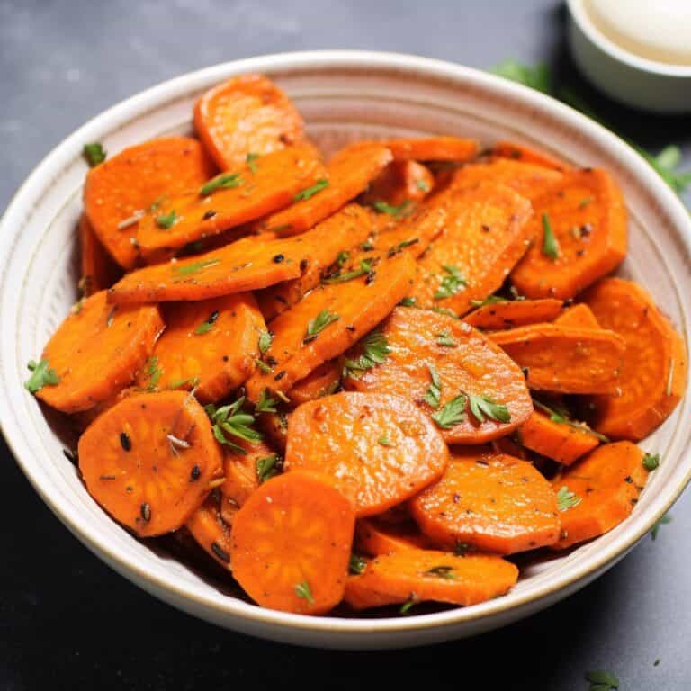 Golden-brown Ranch Roasted Carrots seasoned with herbs on a serving platter, garnished with fresh parsley.