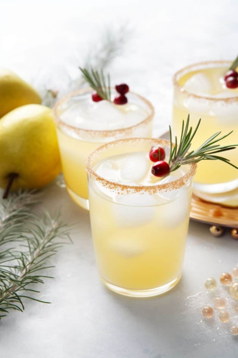 A sparkling Vanilla-Pear Holiday Punch in a glass bowl, featuring pear juice and reposado tequila, beautifully garnished with lemon rounds, cranberries, and rosemary for a festive touch.