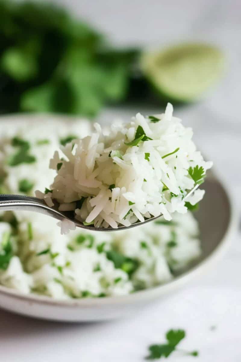 Close-up of a spoonful of Cilantro Lime Rice, highlighting its Chipotle taste-alike flavor, ready to complement any family dinner or burrito bowl.