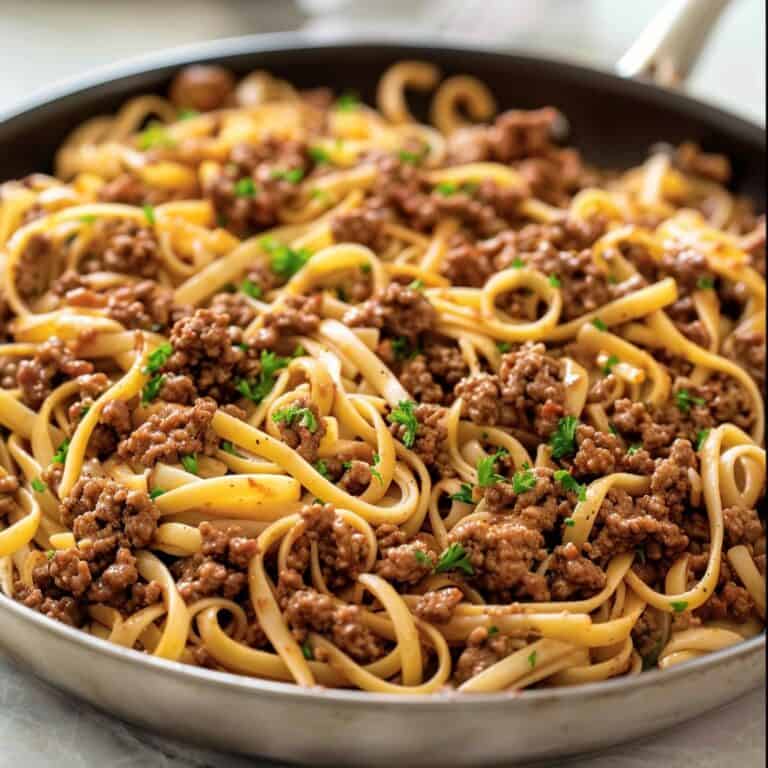 Mongolian noodles with ground beef in skillet.