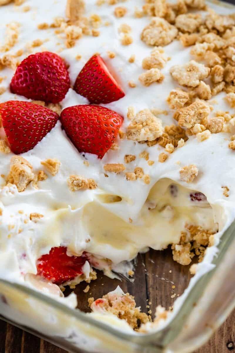 A creamy no bake strawberry shortcake trifle with layers of cake, strawberries, and whipped cream, topped with crunchy granola.