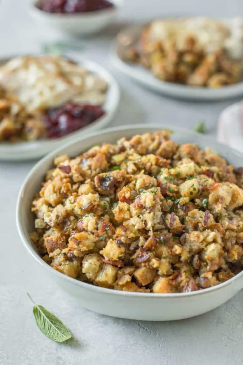 A large bowl of hearty Thanksgiving stuffing, filled with chunks of bread, diced vegetables, and fresh herbs, ready to serve alongside holiday dishes.