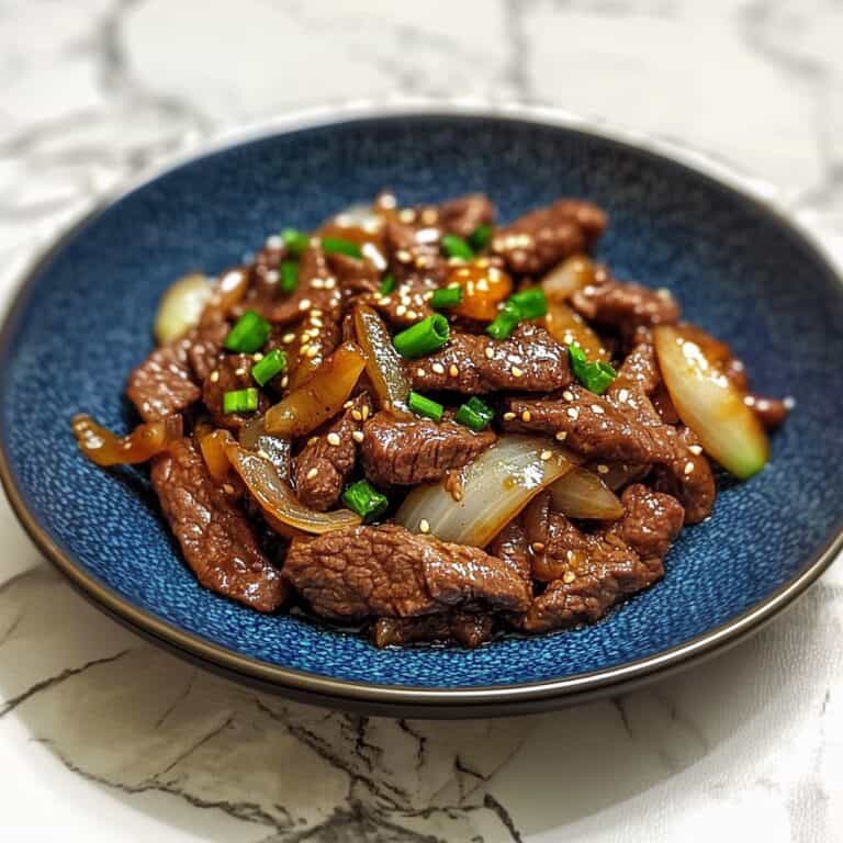 Bring a taste of authentic Chinese flavors home with this Beef and Onion Stir Fry. Juicy beef and sweet onions come together in a savory sauce, garnished with green onions for the perfect finishing touch. Ideal for weeknight dinners and Asian food lovers.