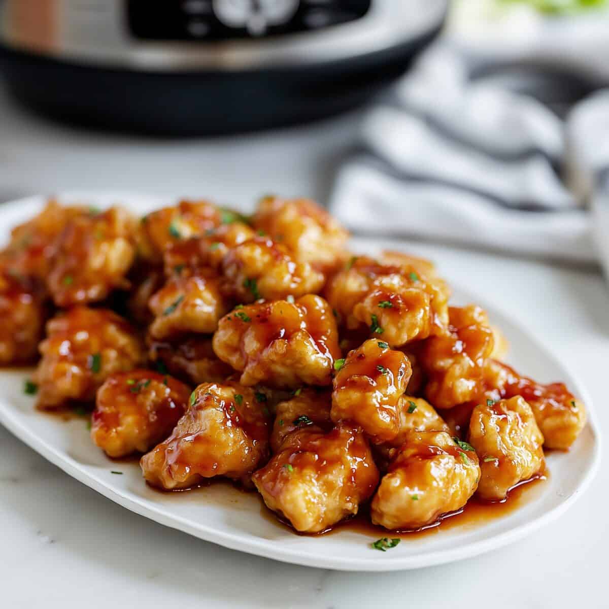 Slow cooker orange chicken with sticky sweet sauce, featured in easy crockpot chicken recipes for busy weeknights.